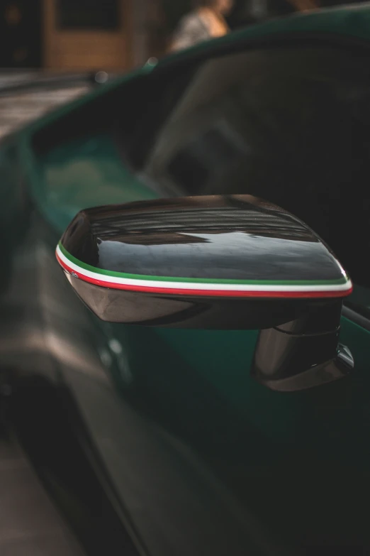 car door and side view mirror with an italian flag painted on it