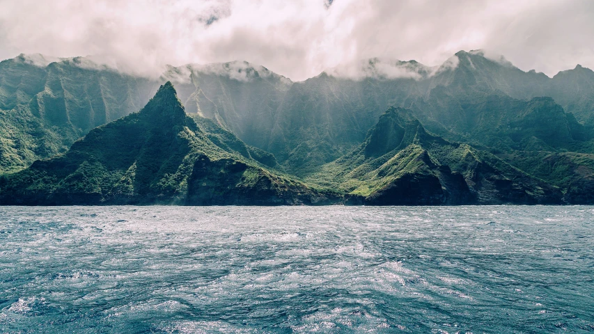 the clouds are rolling over a mountain range