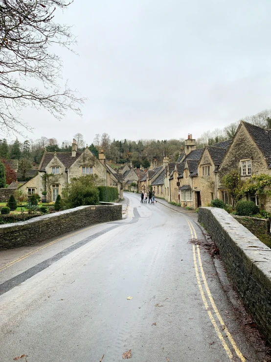 the narrow city street is empty and wet