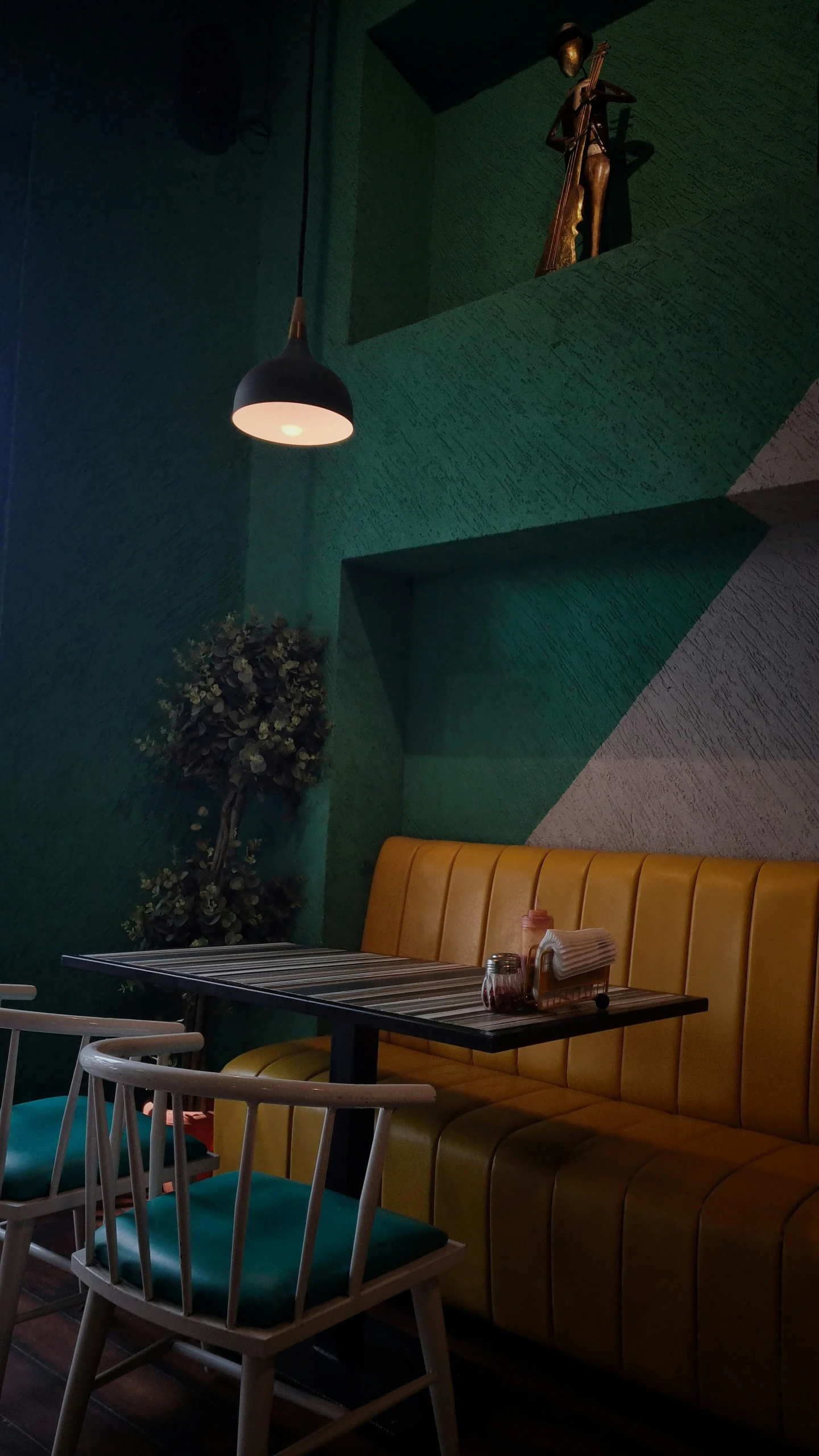 a restaurant table with chairs and a black chair