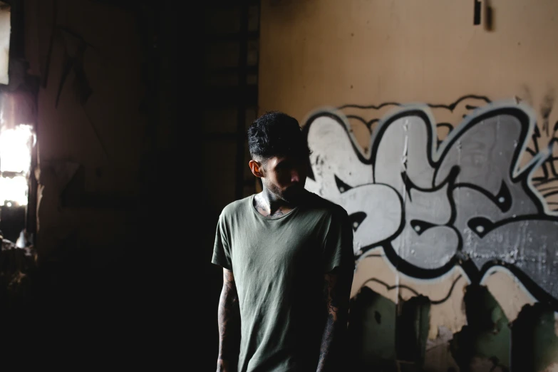 a man stands in front of an art - themed wall