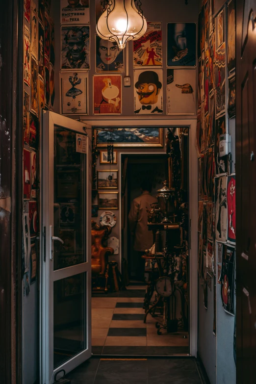a man and child inside of a doorway covered in comic books