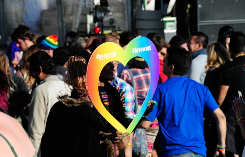 a heart balloon that says typographa and is held up by the head of a man