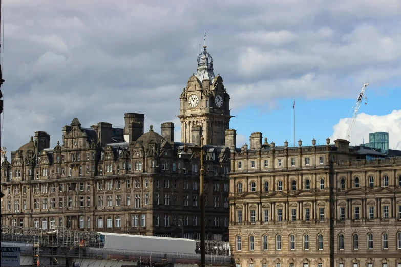 many buildings next to each other under cloudy skies