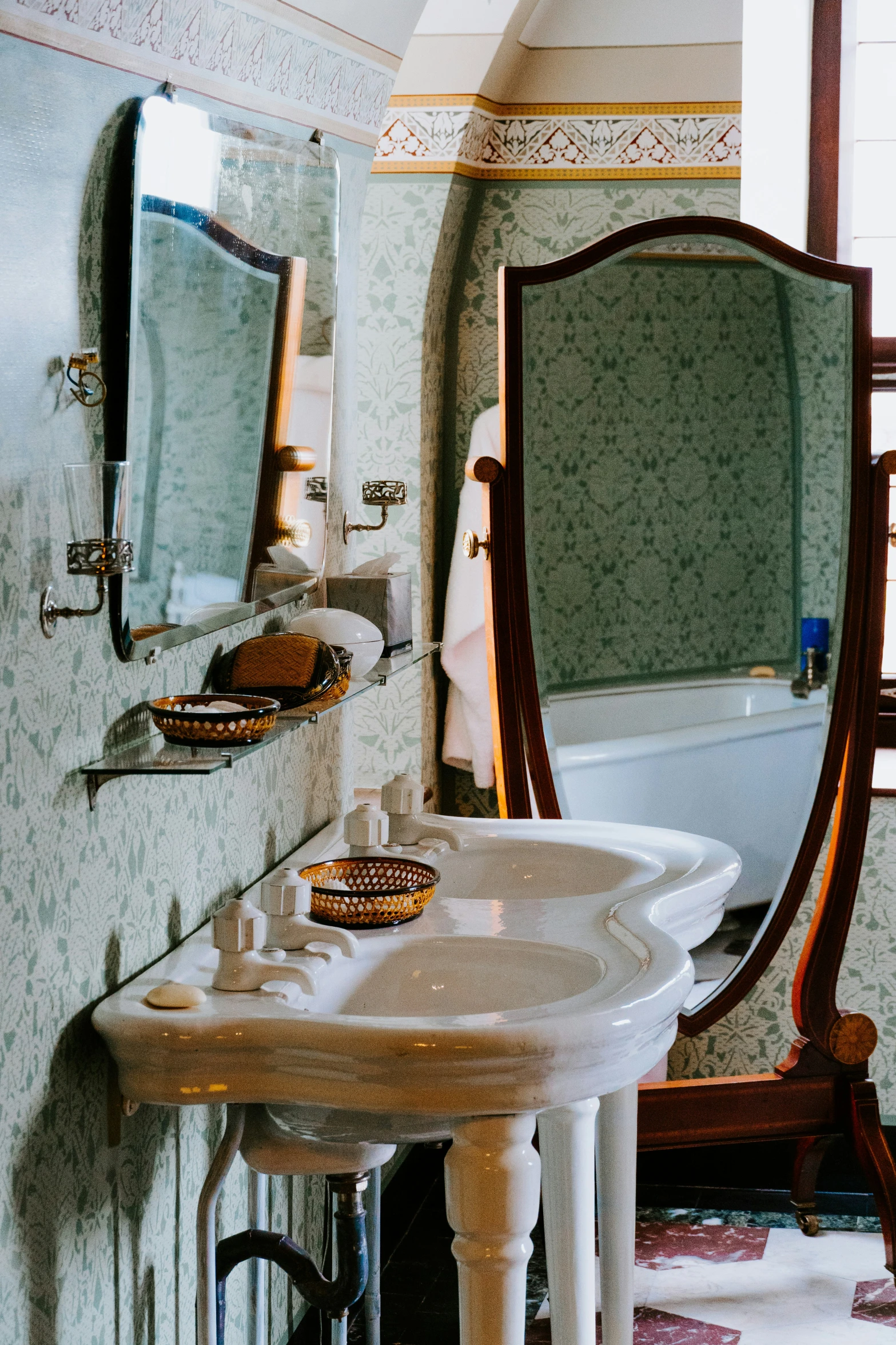 a bathroom with marble walls and white fixtures