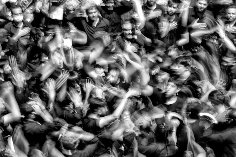 blurry image of people praying and waving