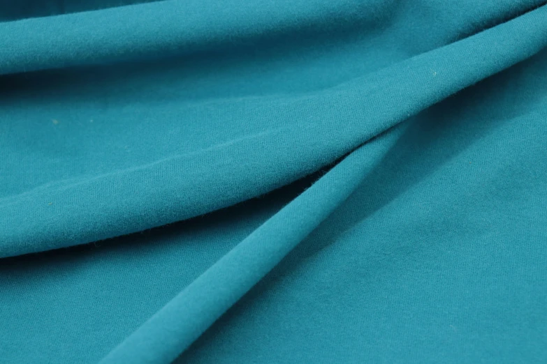 the bottom of a teal colored piece of clothing