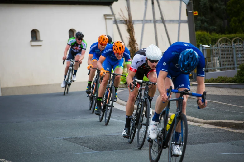 a group of cyclist racing down a street