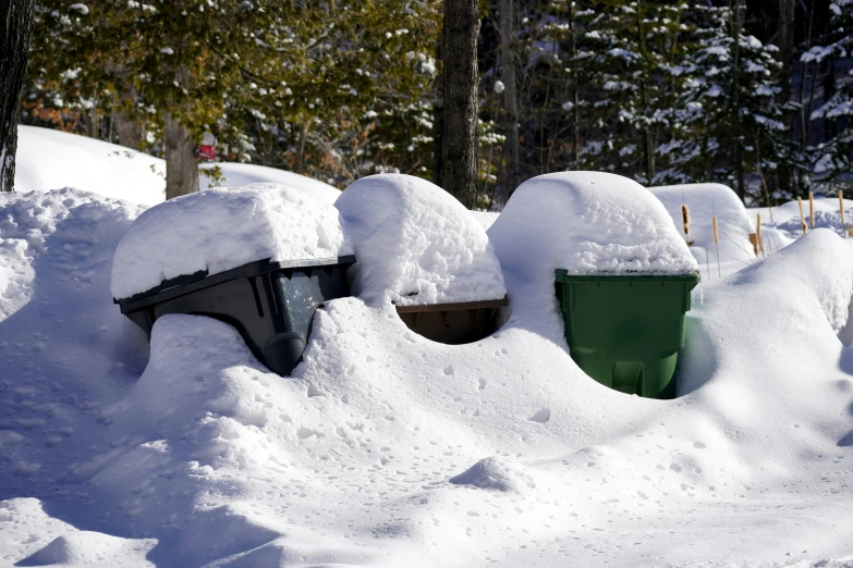 snow piled up in several sections and one with a dumpster