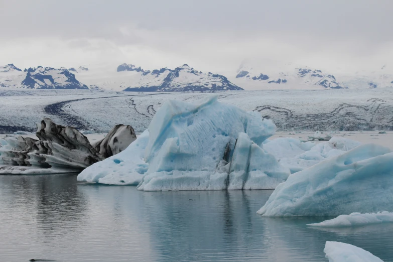 a lake that has some ice on the sides