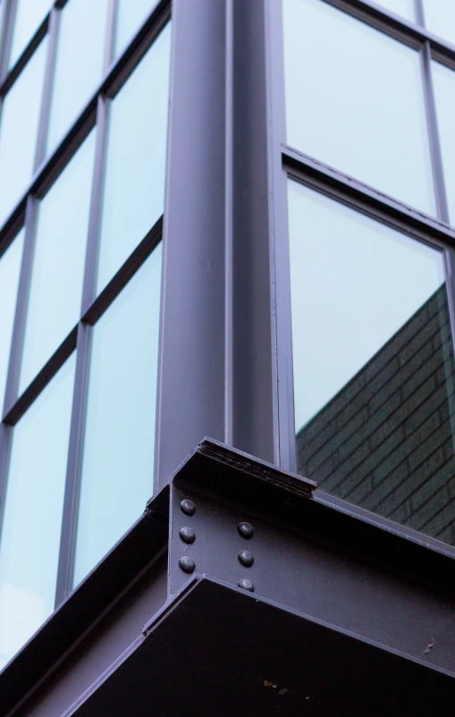 a pole on the outside of a building with many windows