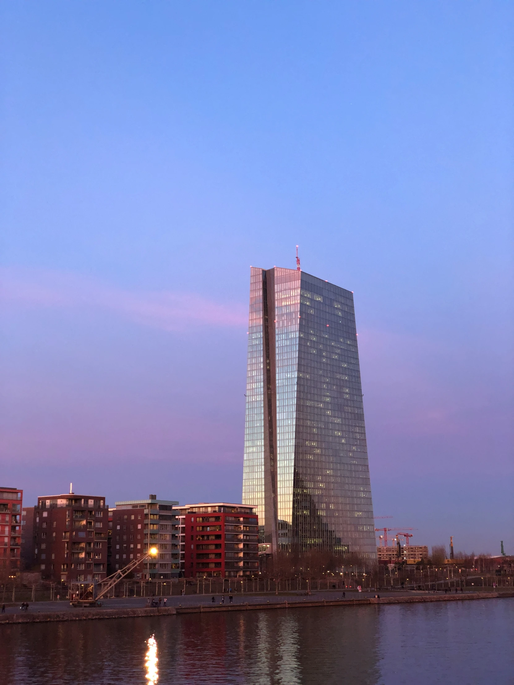 a large building in front of a very tall building