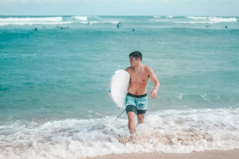 a man with a surfboard in the water