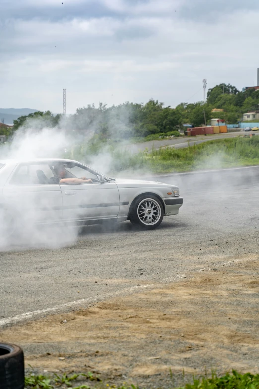 an old fashion muscle car has smoke coming out