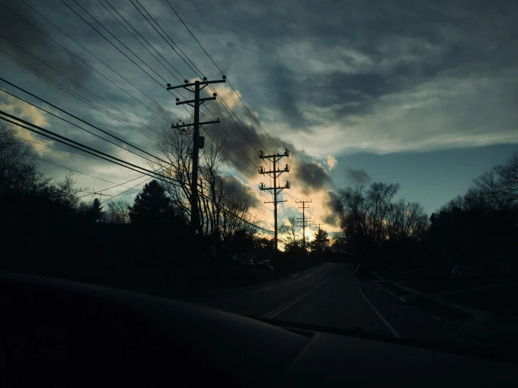 a view of power lines from the backseat of a car