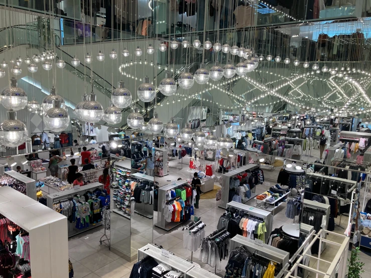 a large room with several lights and clothes on tables