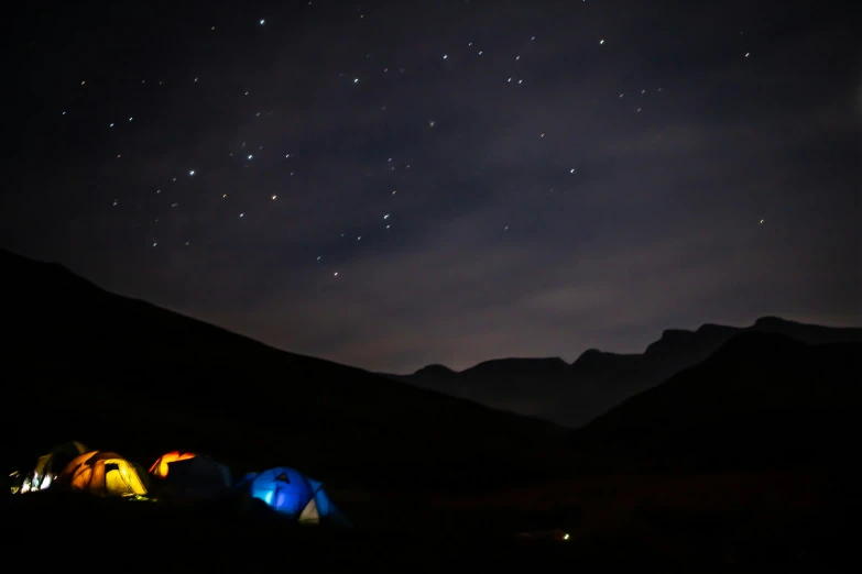 a group of tents on the side of a mountain