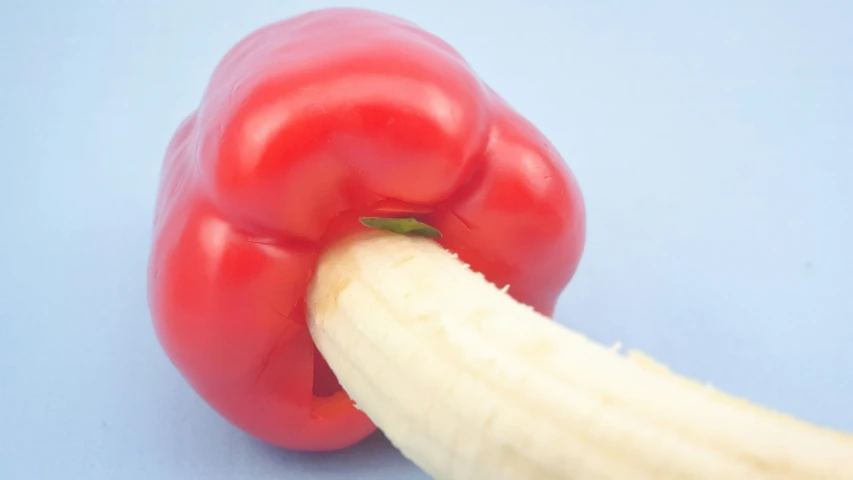 a red pepper and a banana on a blue background