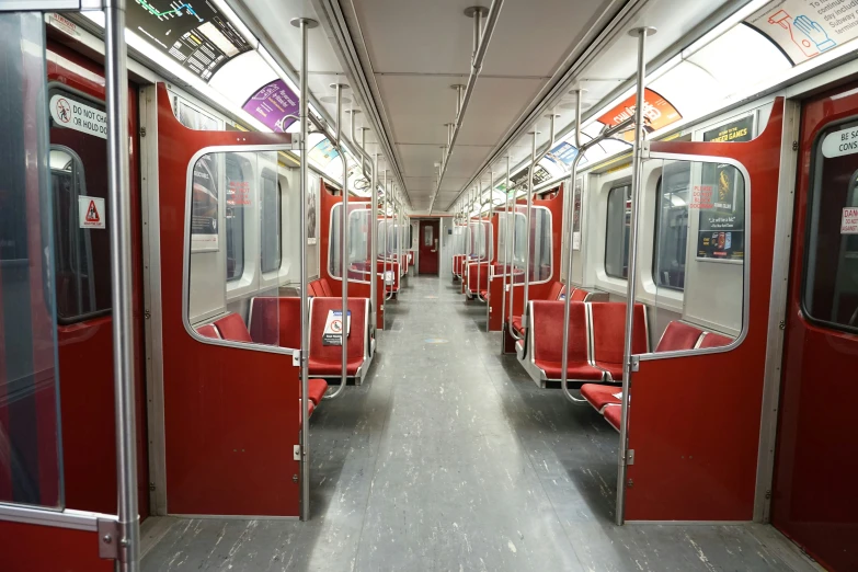 a red subway with red seats and no people