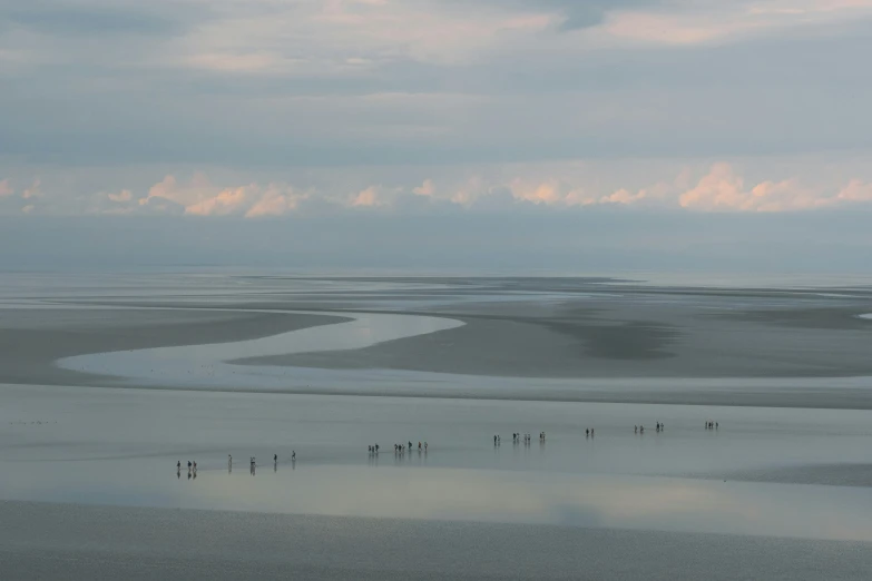 a body of water with some hills in the distance