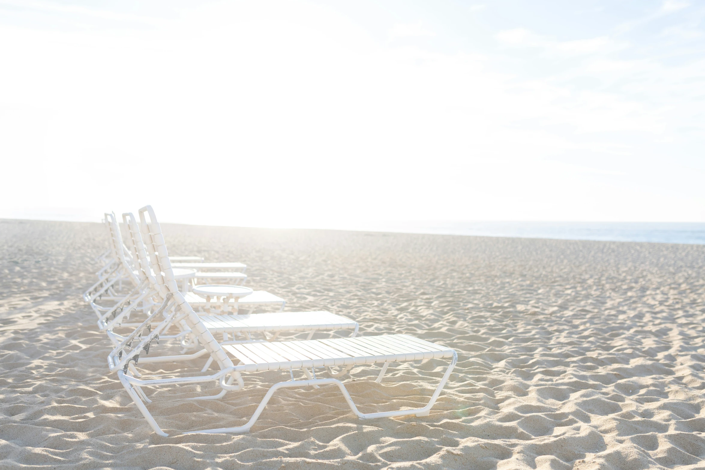 several benches are set out on the sand