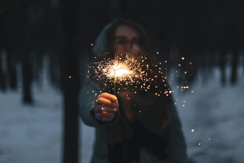 man in the middle of throwing a sparkler at someone