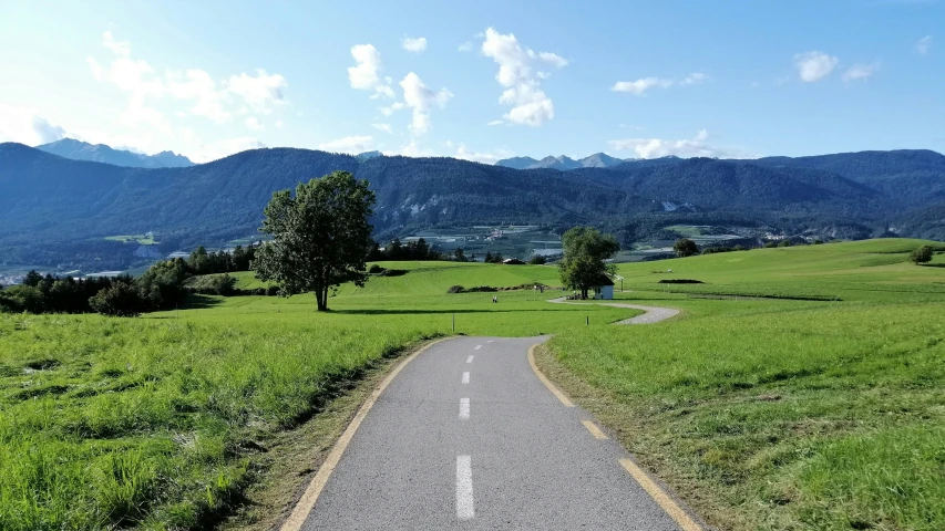 the view from the top of the paved road toward the green hills