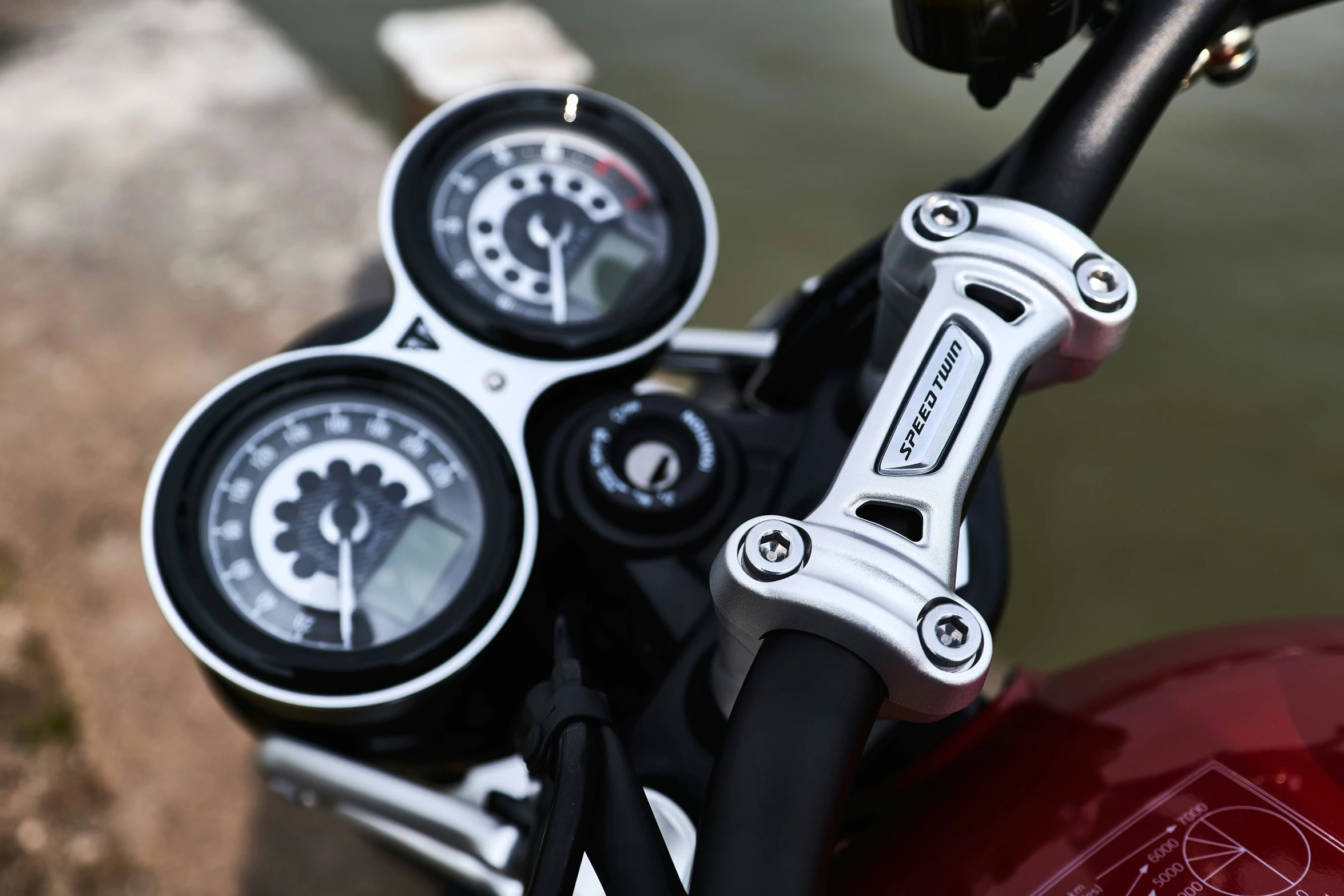 three gauges in the handle bars of a motorcycle