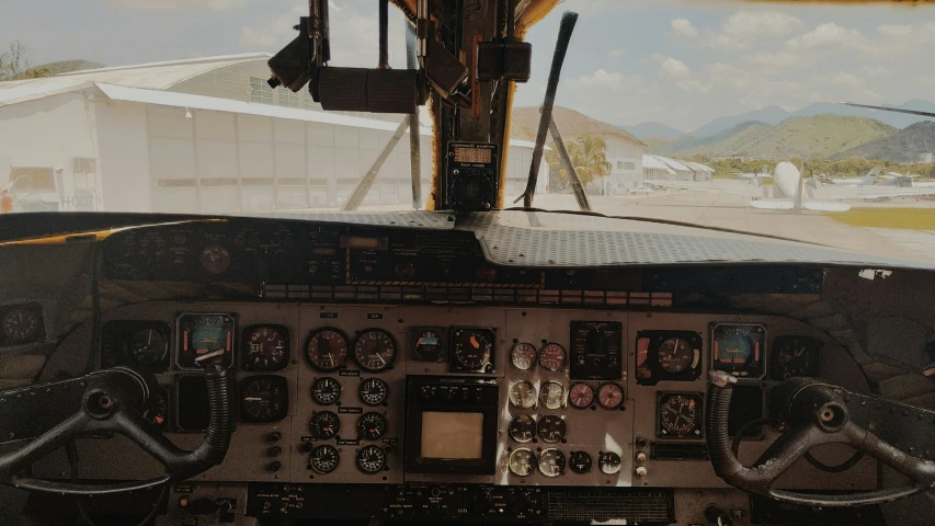 the cockpit area of a airplane with several control ons