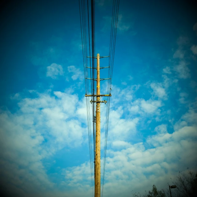 a pole with wires and some electrical wires