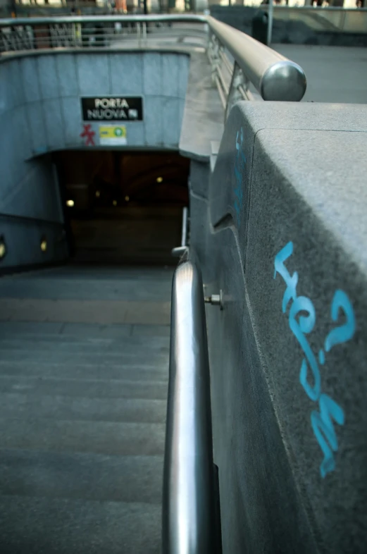 a close - up of stairs and a small sign on the side