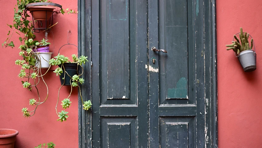 some very pretty old doors on the side of a building