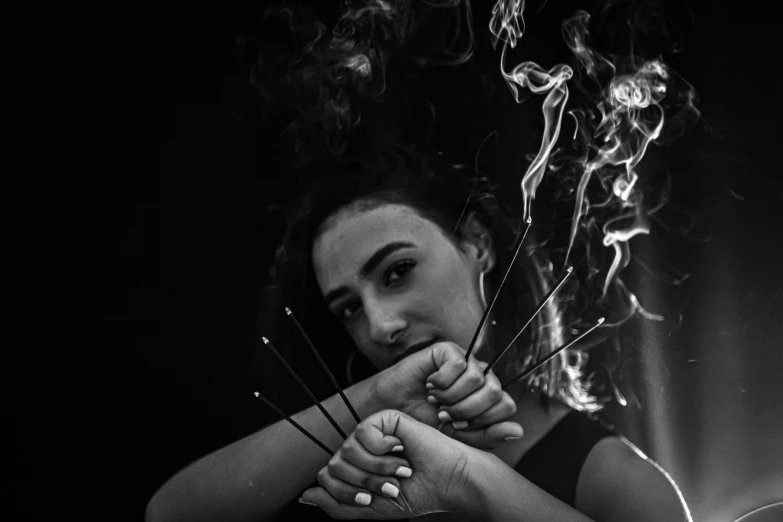 a woman holding a cigarette while smoking cigarettes