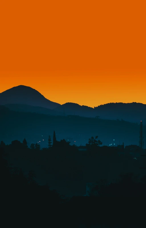 some hills hills and a clock tower at sunset