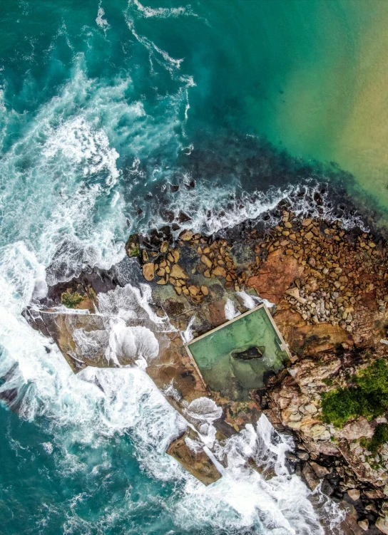 an aerial view of the ocean in the foreground