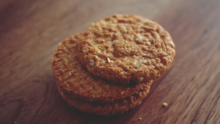 two cookies with peanut er on a wood table