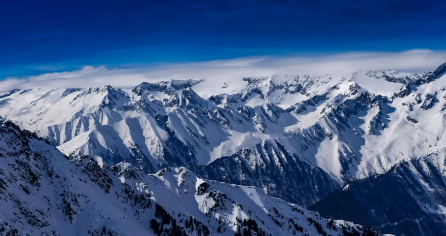 the top of some snowy mountains from a plane window