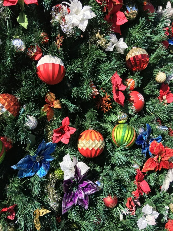 colorful ornaments are placed on top of pine nches