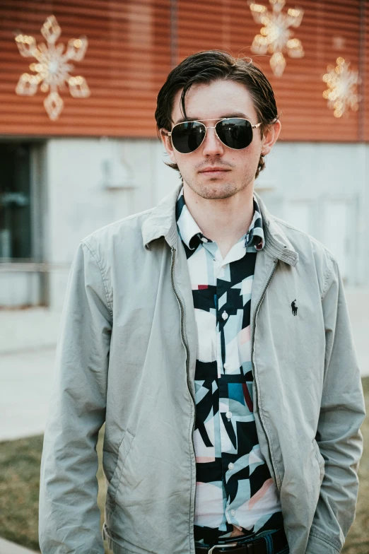 a man with sunglasses and his shirt showing a pattern