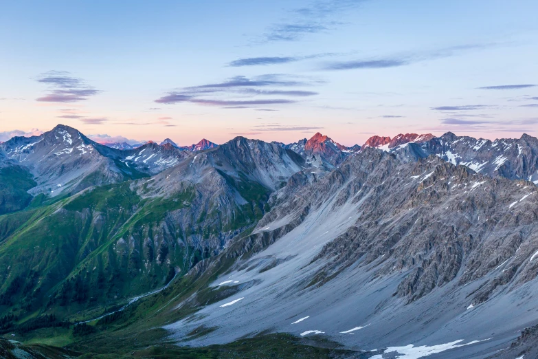 a view of mountains and valleys with sky in the background