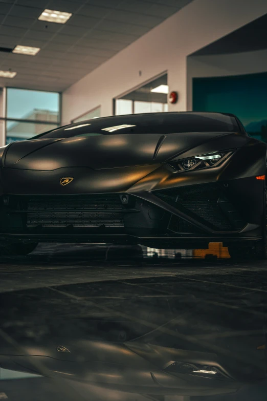 black sports car in an urban garage with a sun shining on it