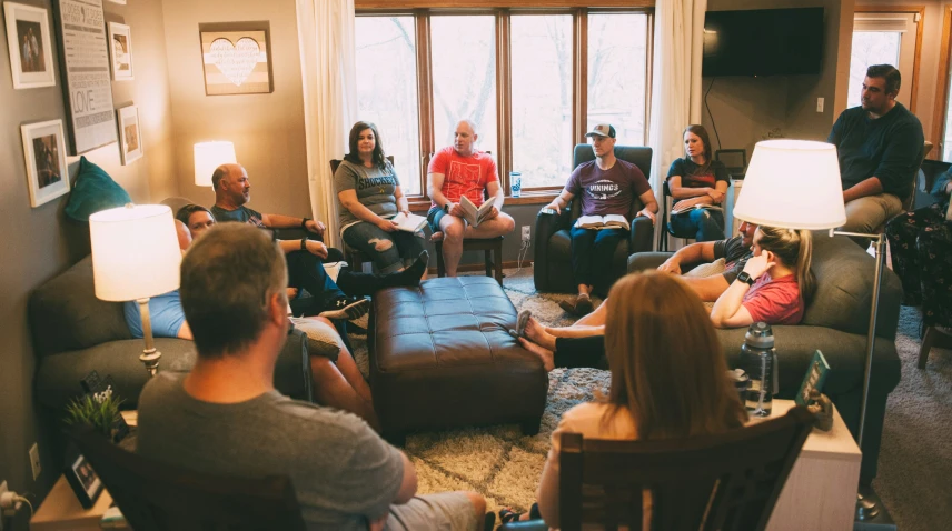 a group of people sitting in chairs in front of a large window