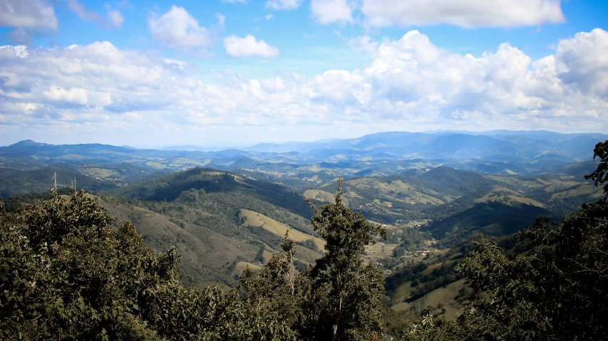 a mountain view of some hills and clouds