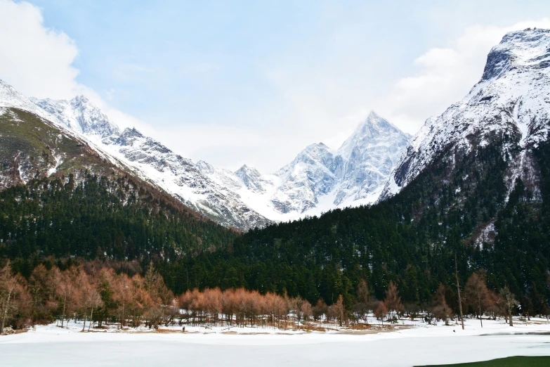 the mountain range is covered with snow and ice