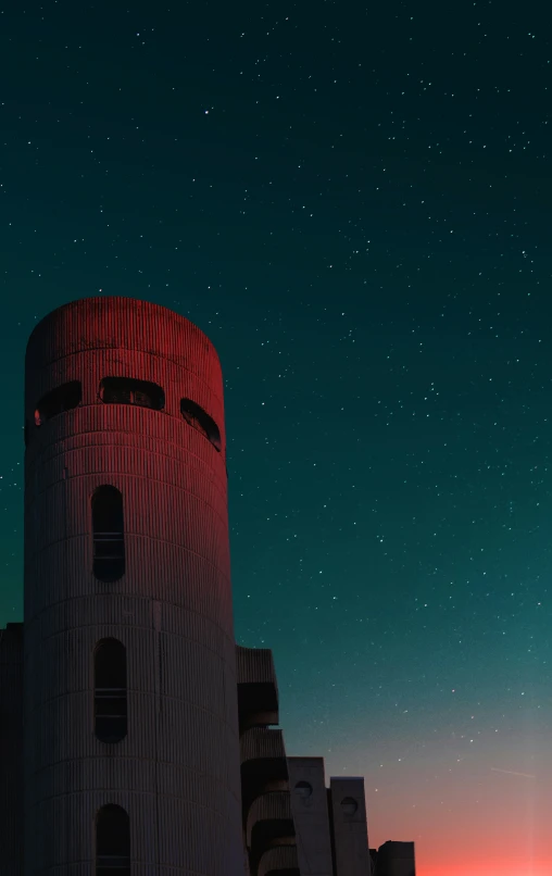 red tower against the night sky with stars