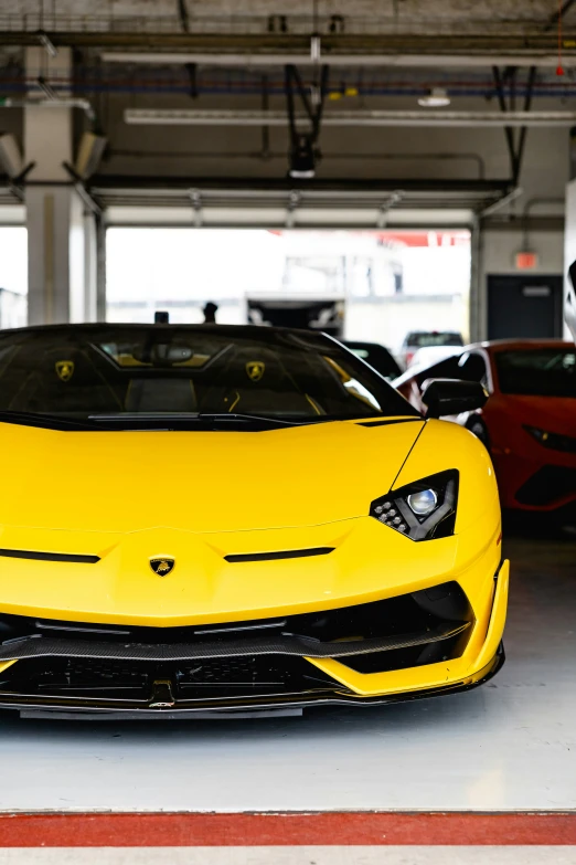 some yellow sports cars are parked in the garage