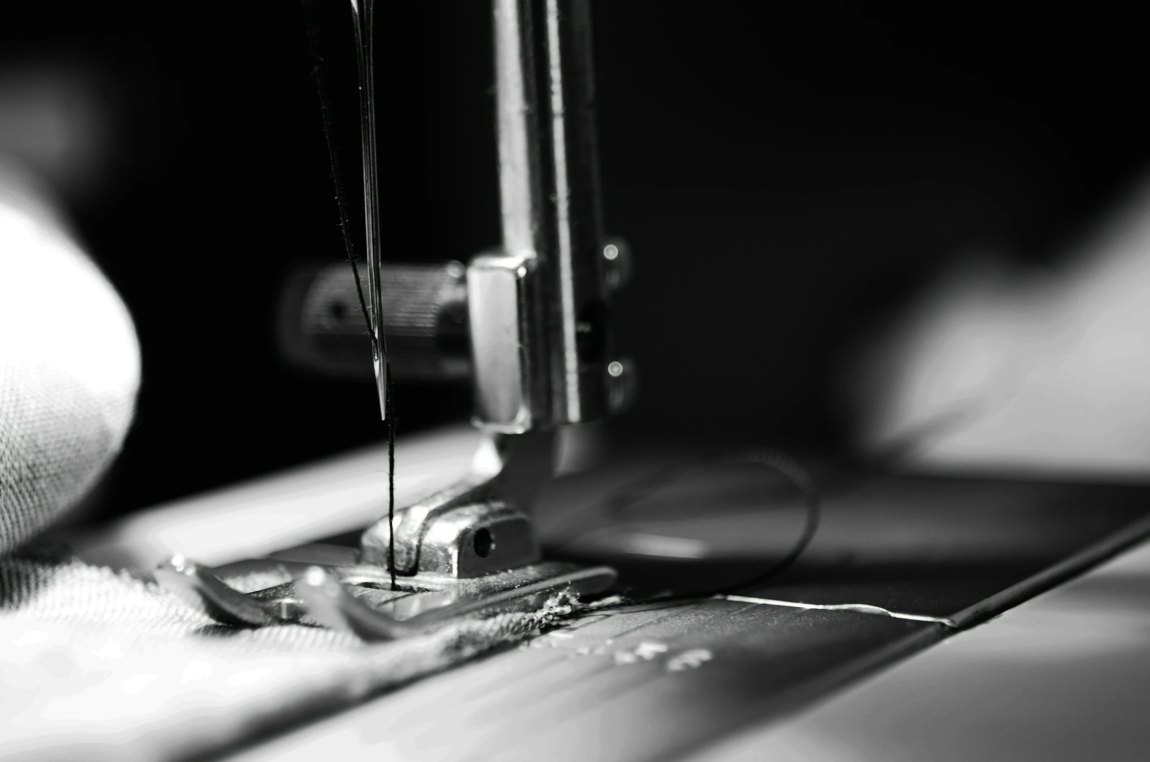 a black and white image of a sewing machine