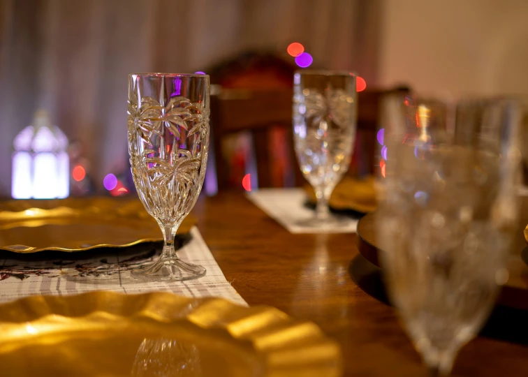 a table with wine glasses and place settings