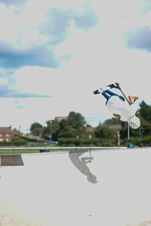 a man doing a skateboard trick with a blue sky background