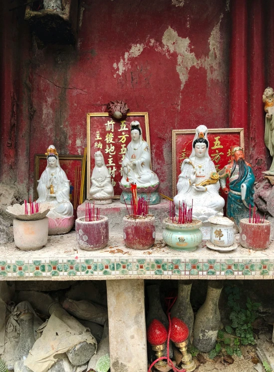 a stone table topped with candles and statues